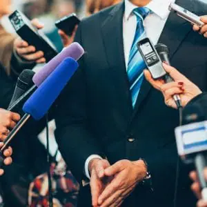 Media taking answers from a man | Law Enforcement Scam Calls