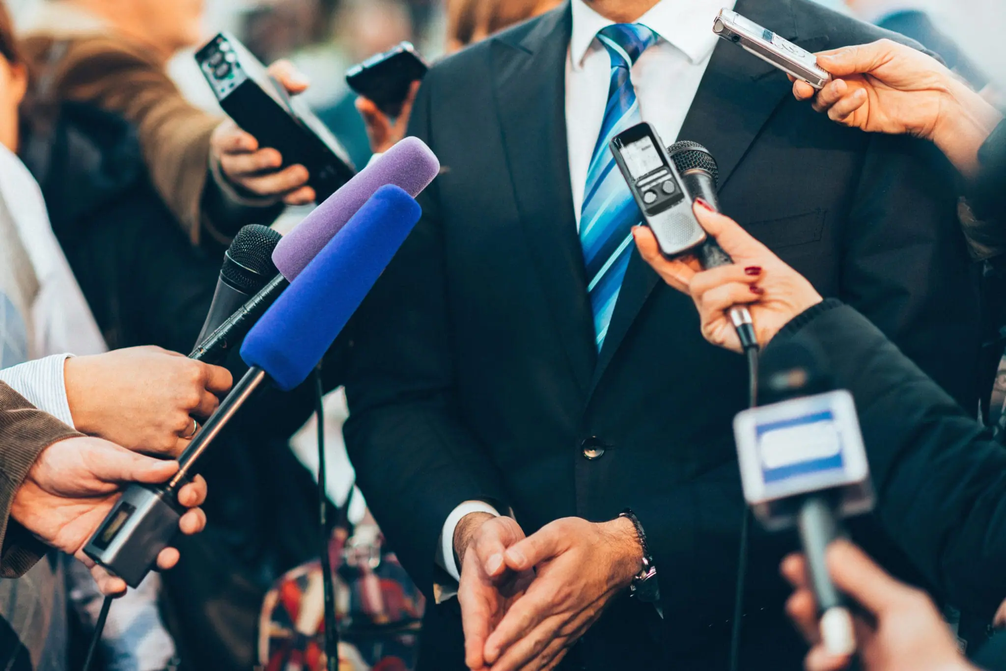 Media taking answers from a man | Law Enforcement Scam Calls