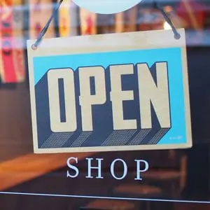 Image of an open sign at a store | RPA Lifestyle Creep Article