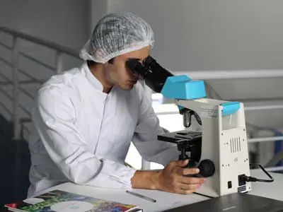 Medical Staff looking into a microscope | Free COVID-19 Testing