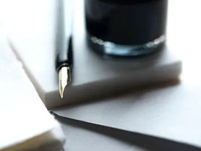 MCOLES Considers Police Reforms | Pen on slate with a black cup | 1033 Program