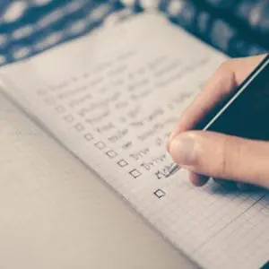 Person writing to do list on paper | Financial To Do List | Beneficiary Information