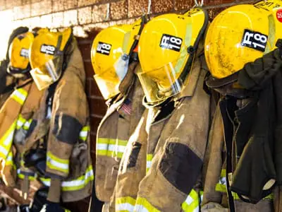 Firefighter uniforms hanging on a wall
