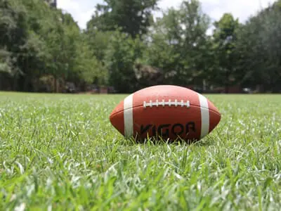 Football laying on green grass | NFL Response