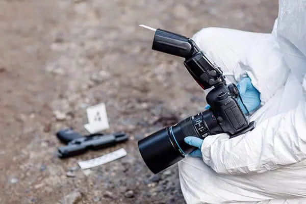 Close-up shot of a forensics investigator taking image of crime scene | Basic Crime Scene Photography