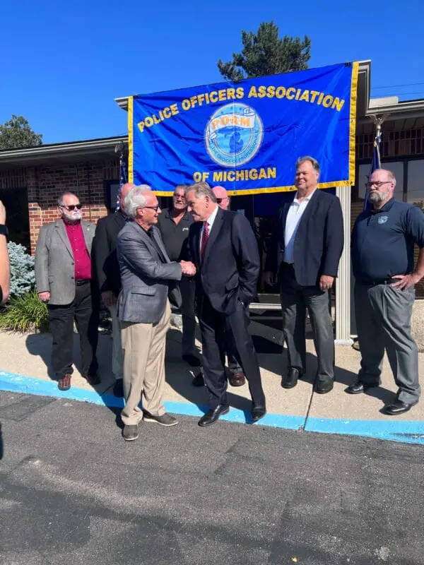 POAM President Jim Tignanelli shaking Mike Rogers hand