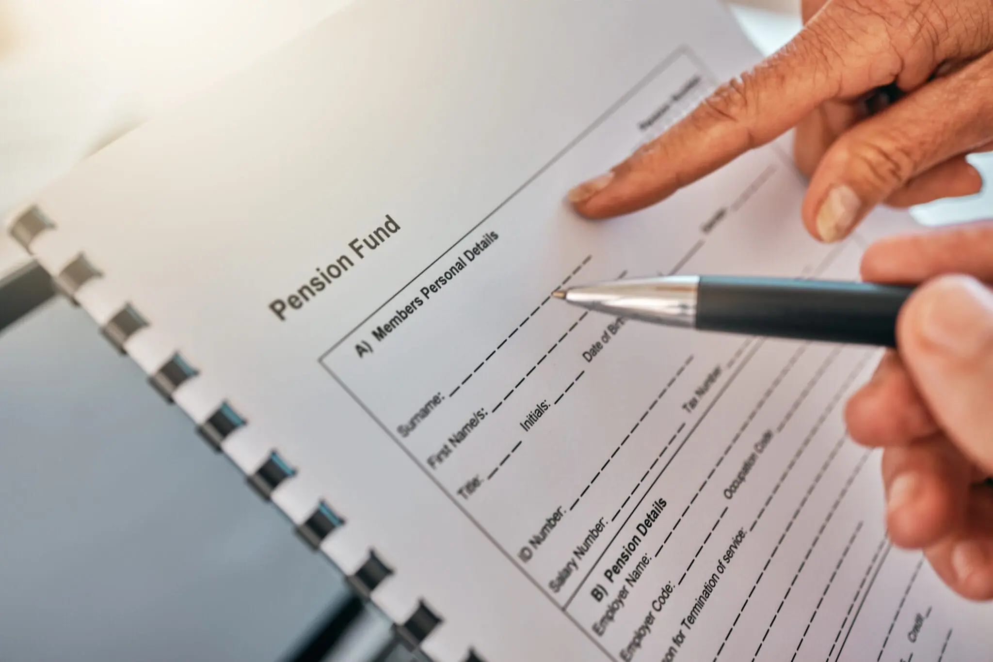 Hand, pension document and pen for writing