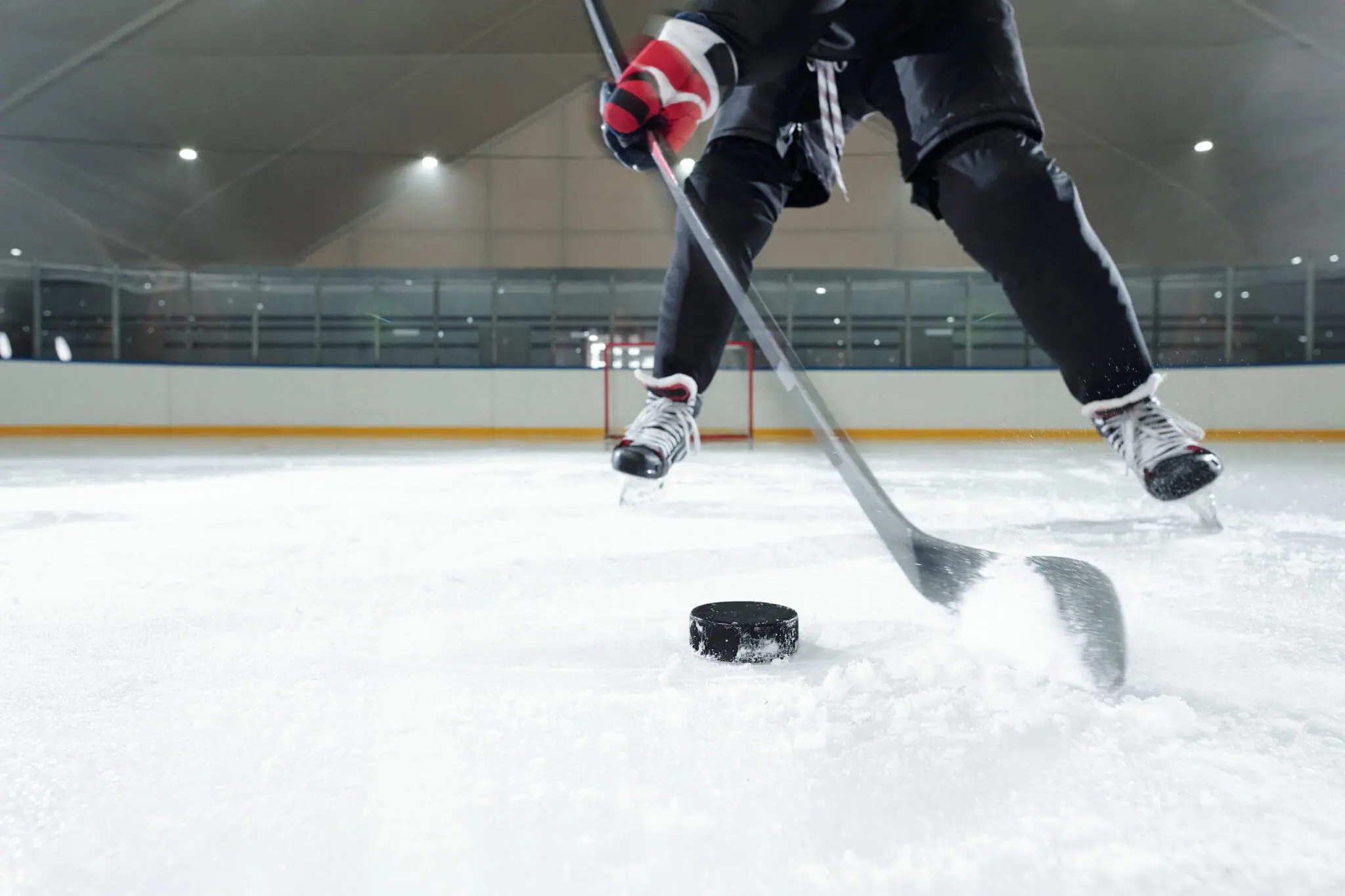 Hockey player shooting puck for Motor City Rockers