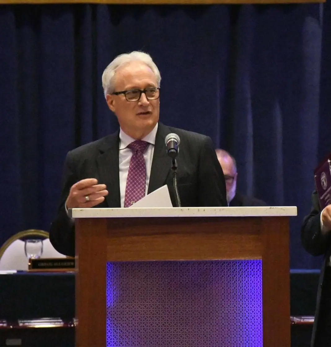 POAM Spring Update-POAM President Jim Tignanelli stands at a podium addressing members