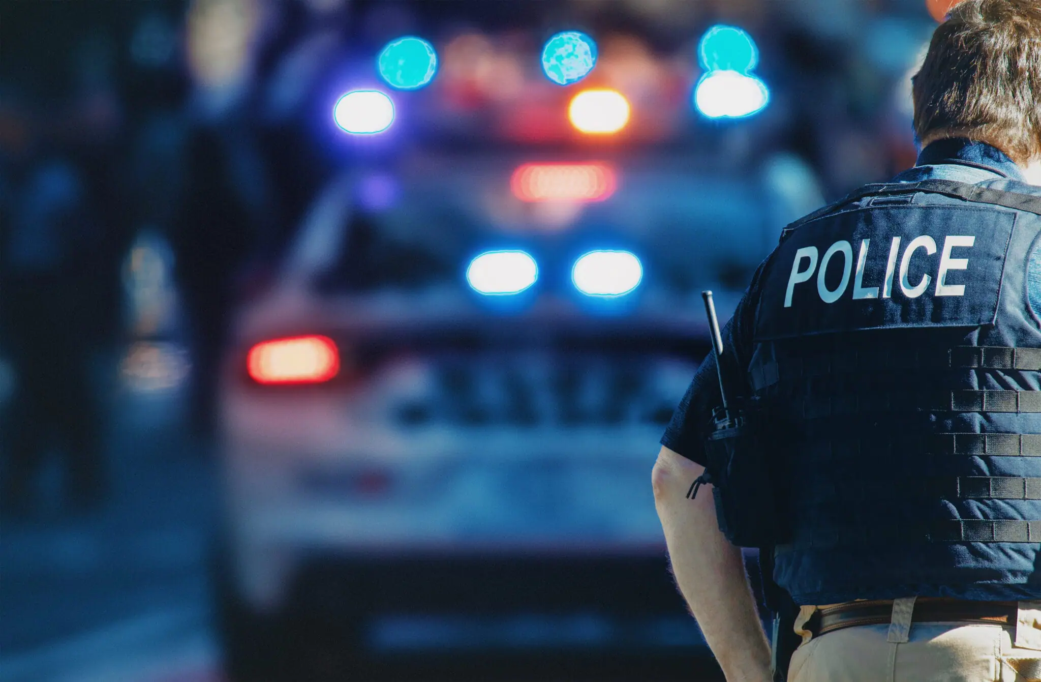 NDAA Advances Pro-police measures - police in front of cop car