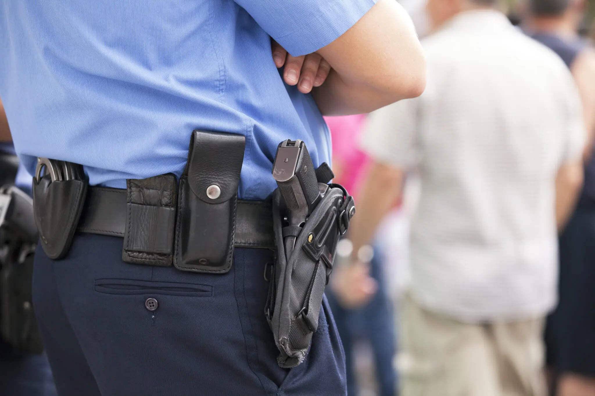 Harsher Penalties For Disarming Officers - Police Officer with gun holster